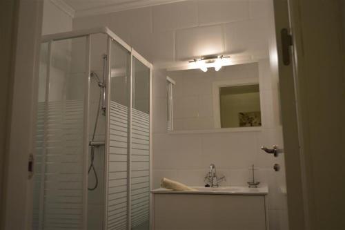 a bathroom with a shower and a sink and a mirror at Casa Lucero in Rojales