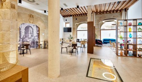 a room with tables and chairs in a building at Sercotel Calle Mayor in Logroño