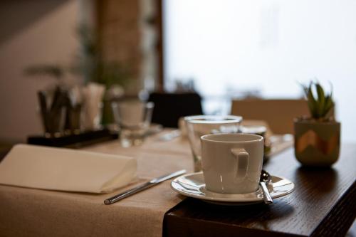 a wooden table with a coffee cup on top of it at Sercotel Calle Mayor in Logroño