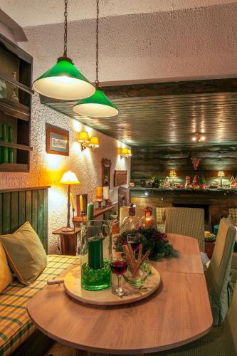 a dining room with a table with wine glasses on it at Dandy Villas Agoriani - Chalet Ivoni - Fireplace in Eptalofos