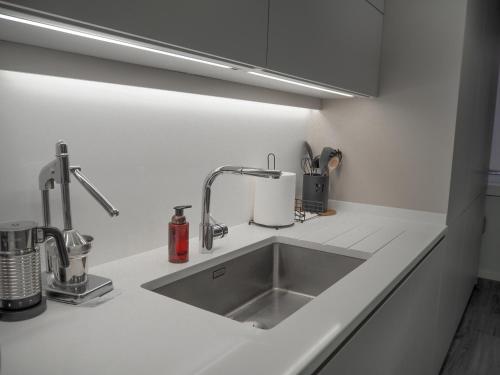 a kitchen counter with a sink in a kitchen at Imperatriz Madeira Apartment in Funchal