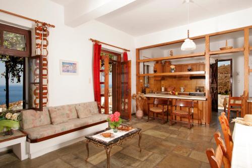 a living room with a couch and a table at Villa Kapare in Kókkinon Khoríon