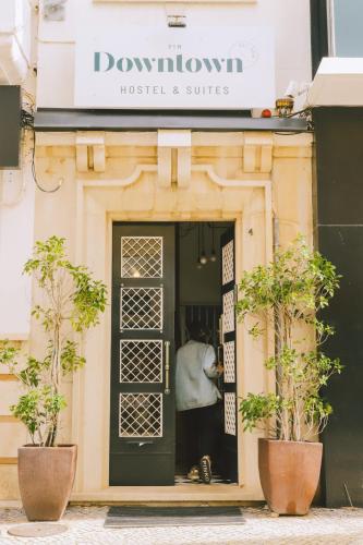a person standing in the door of a hostel and suites at PTM DownTown Hostel&Suites in Portimão