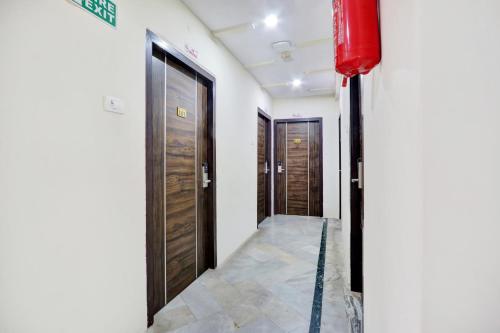a hallway with two doors and a red fire hydrant at Super Hotel O MVP Double Road in Visakhapatnam