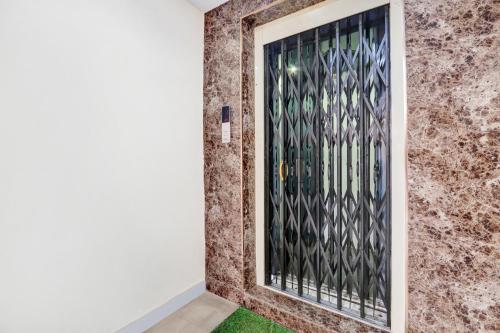a door with a metal gate in a room at Super Hotel O MVP Double Road in Visakhapatnam