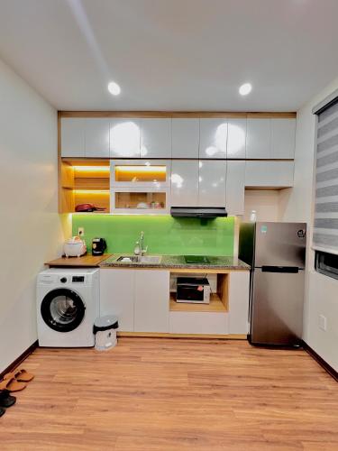 a kitchen with a washer and a sink and a refrigerator at HPT Home II Vinhome Marina chuỗi Apartment - Homestay in Hai Phong