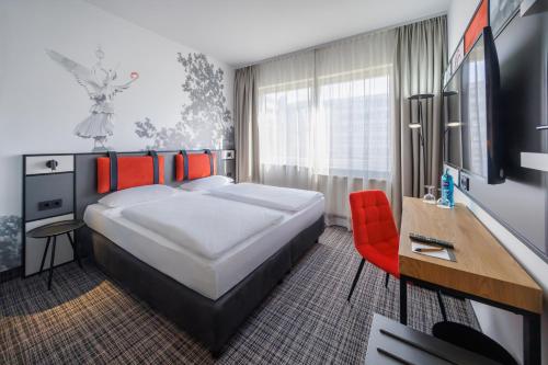 Postel nebo postele na pokoji v ubytování Hotel Lützow
