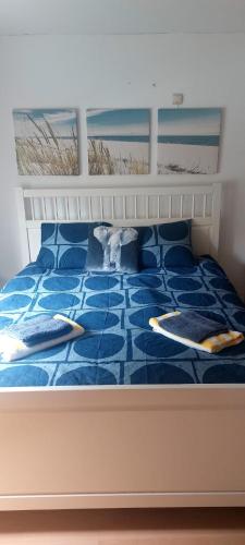 a bed with two pillows on top of it at Centraal appartement met tuintje, vlak bij zee in De Panne