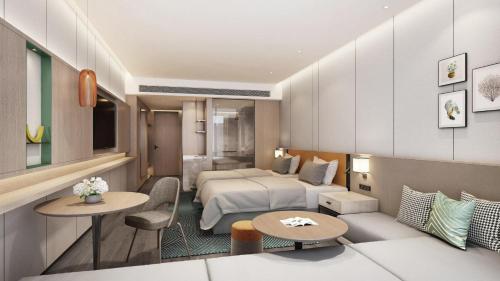a hotel room with a bedroom and a bed at Holiday Inn Quanzhou Donghai by IHG in Quanzhou