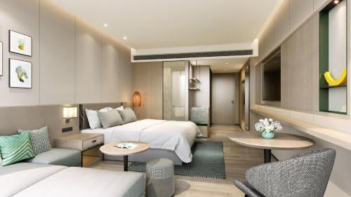 a hotel room with two beds and a living room at Holiday Inn Quanzhou Donghai by IHG in Quanzhou