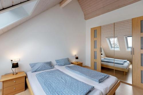a bedroom with a large bed and a mirror at Obstbau Koch in Bodman-Ludwigshafen