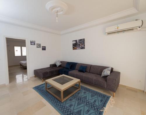 a living room with a couch and a table at Flamingo Apartment 4 in Fouchana