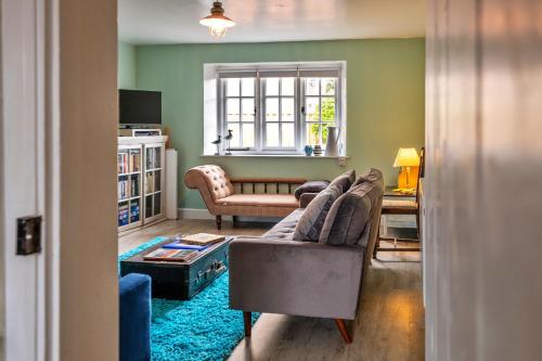 a living room with a couch and a table at Finest Retreats - 3 Elm Cottage in Carhampton