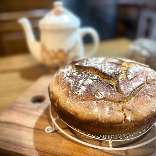 a loaf of bread on a plate on a table at Monte Paradiso Agriturismo in Pietralunga