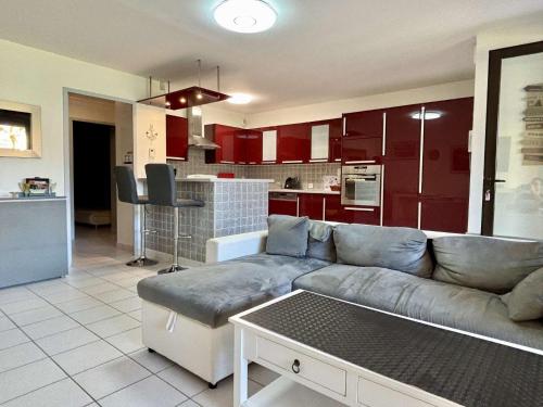 a living room with a couch and a kitchen at Appartement 3 pièces- 4 personnes- ARGELES VILLAGE AR075-012 in Argelès-sur-Mer
