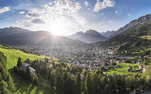 a city in a valley with mountains in the background at Hotel Funivia in Bormio