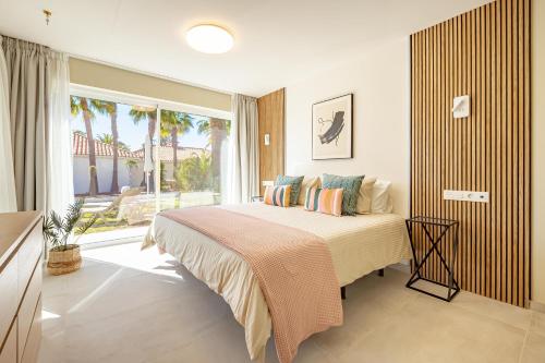 a bedroom with a bed and a large window at LUXURY Sun Club 252 in San Bartolomé de Tirajana