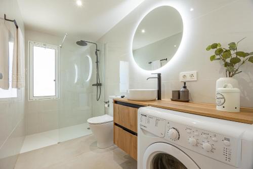 a white bathroom with a washing machine in it at LUXURY Sun Club 252 in San Bartolomé de Tirajana
