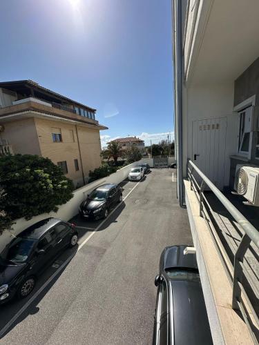 two cars parked in a parking lot on a street at Simo'sunset House in Focene