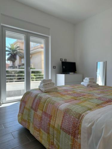 a bedroom with a bed with towels on top of it at Simo'sunset House in Focene