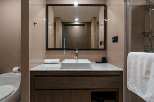 a bathroom with a sink and a toilet and a mirror at View 2Bdr Lux Life Rawai in Rawai Beach