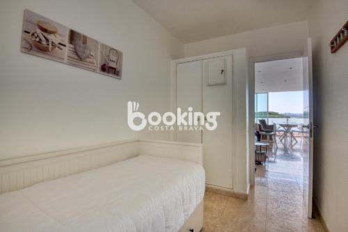 a bedroom with a bed and a dining room at Kaminias Apartament amb vistes al mar reformat per 4 persones in Platja  d'Aro