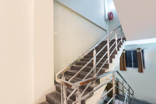 a staircase in a building with a metal railing at FabHotel Simhadri Grand-Nr Khammam Railway Station in Khammam