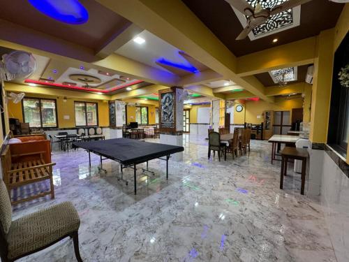 a dining room with a table and chairs at Arav Resort in Katrab
