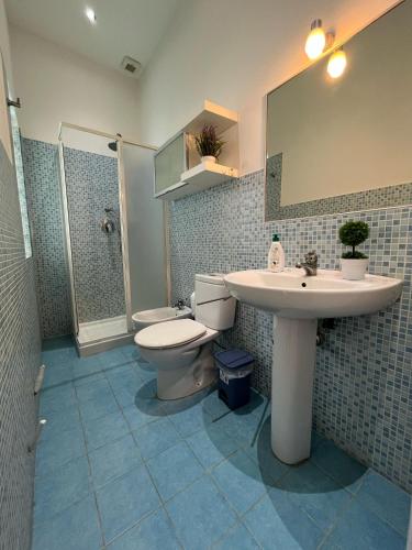 a bathroom with a sink and a toilet and a mirror at Sea House in Catania