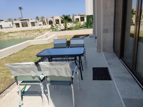 a group of tables and chairs on a balcony at Two bedroom Villa with Private Pool, Hawana Salalah in Wādī Khasbar