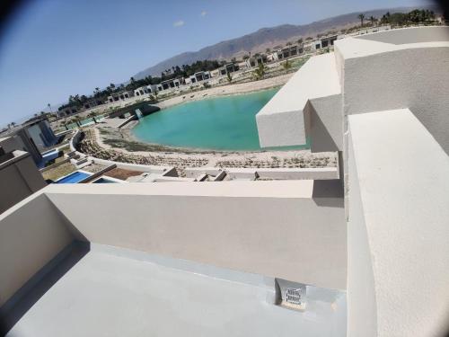 a view of a swimming pool from a building at Two bedroom Villa with Private Pool, Hawana Salalah in Wādī Khasbar