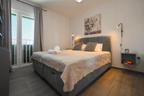 Postel nebo postele na pokoji v ubytování il Centro Apartments Novalja