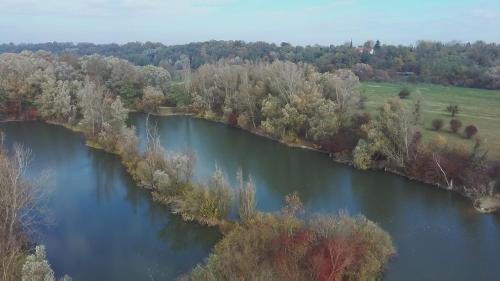 an aerial view of a river with trees and a field at Kamilla Apartmanház Somogyudvarhely OLYANMINTOTTHONCSAKMÉGJOBB in Somogyudvarhely