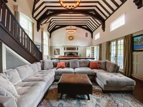 a large living room with a large couch and a table at Holden Frost House in Franconia