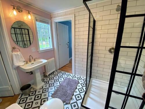 a bathroom with a shower and a sink at Holden Frost House in Franconia