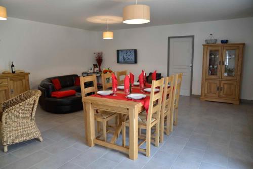 a living room with a table and chairs and a couch at Gîte La Maison d'Alphonse 7/8 personnes in Saint-Léger-du-Malzieu