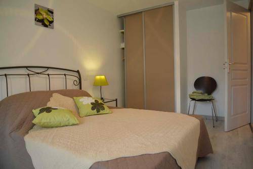 a bedroom with a bed with two pillows on it at Gîte La Maison d'Alphonse 7/8 personnes in Saint-Léger-du-Malzieu