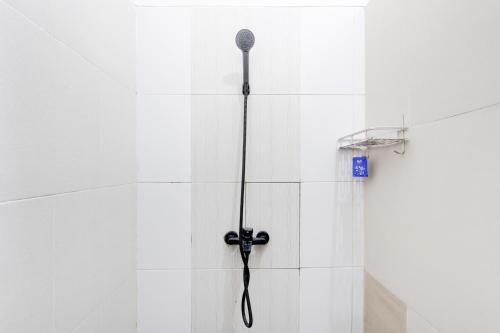 a microphone is hanging on the wall of a shower at Capital O 94274 Homestay Balimoelih in Yogyakarta