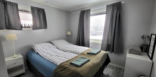 a bedroom with a bed with two towels on it at Perfect apartment for whale safari at Skjervøy! in Skjervøy