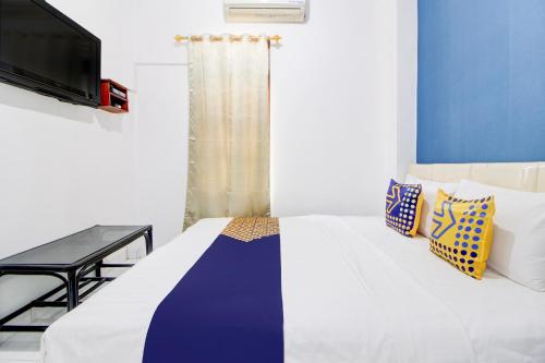 Postel nebo postele na pokoji v ubytování Hotel O Daffsell Homestay Syariah