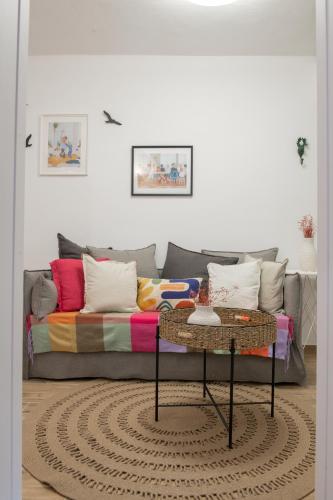 a living room with a couch and a table at Mazi Rooms z in Giannitsa