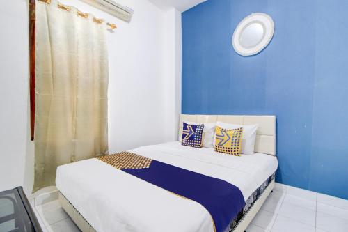 Postel nebo postele na pokoji v ubytování Hotel O Daffsell Homestay Syariah