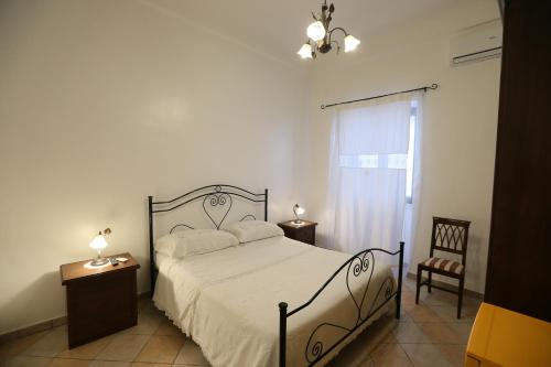 a bedroom with a bed and two tables and a window at A Casa Di Silvia B&B in Sannicola
