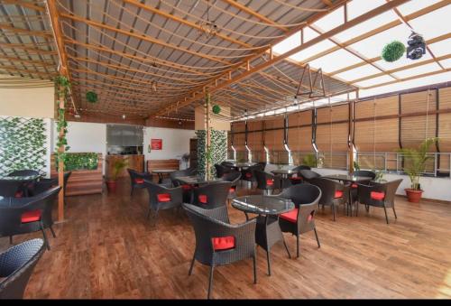 a restaurant with tables and chairs in a room at Hotel yours pacific in Dehradun