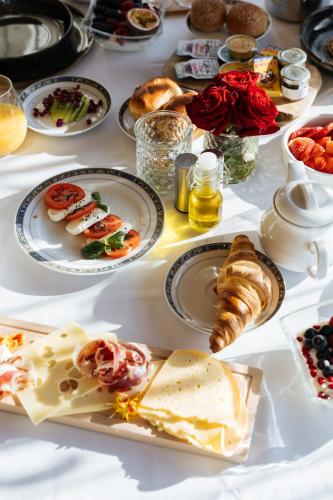 a white table with plates of food on it at Boutique Hotel Azur in De Haan