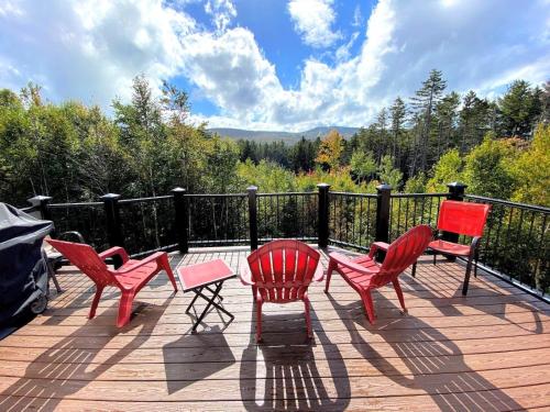 four red chairs and a table on a deck at HL96 Single family home with views and lots of space Privacy convenience AC and style in Carroll