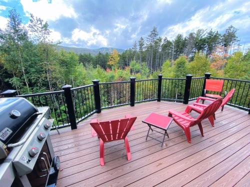 a deck with three chairs and a grill on it at HL96 Single family home with views and lots of space Privacy convenience AC and style in Carroll