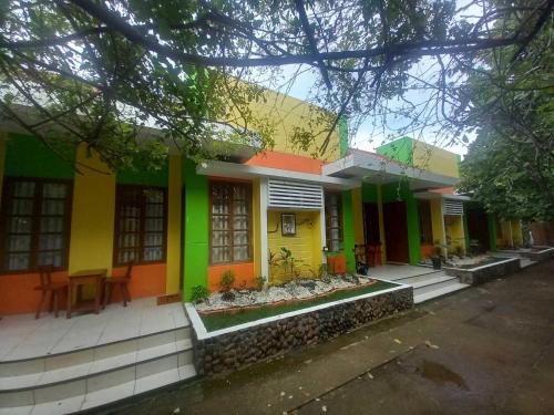 a colorful house with a table in front of it at Casa Felicisima Inn in Puerto Princesa City