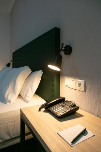 Кровать или кровати в номере Sercotel Las Casas de los Mercaderes