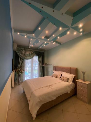 a bedroom with a bed with lights on the ceiling at LaBelle Elite House in Aridaia,Lutra Pozar in Aridaia